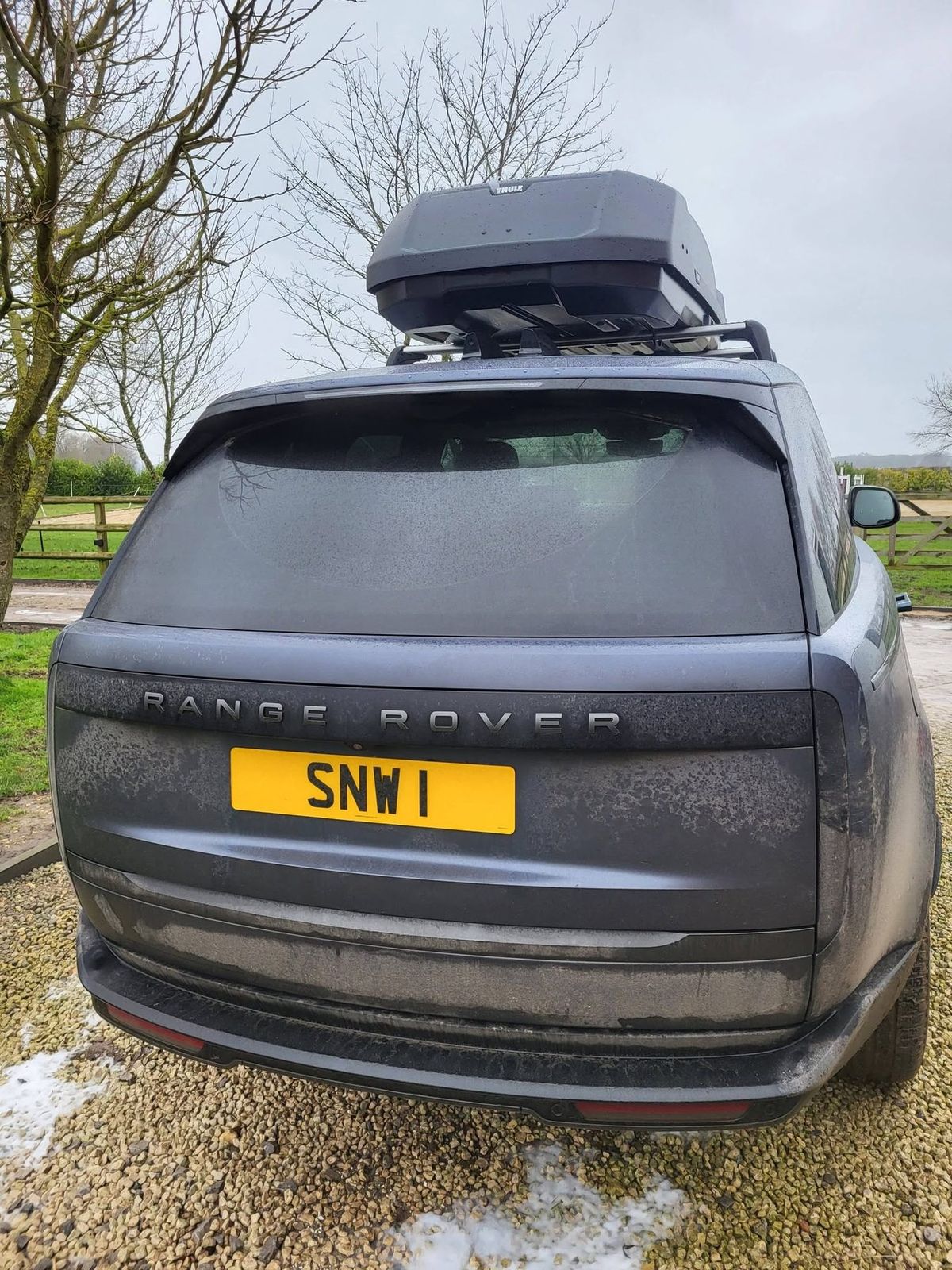 Rear of a large grey four-wheel drive before valeting, tailgate, bumper and glass dulled by a film of winter road salt